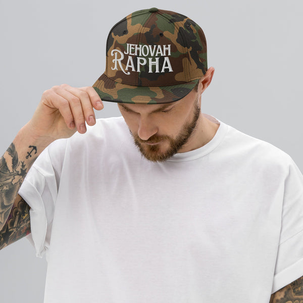 Man wearing camo Jehovah Rapha flat bill trucker hat