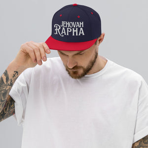 Man wearing red Jehovah Rapha flat bill trucker hat