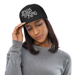 Woman wearing Jesus Is King classic trucker hat