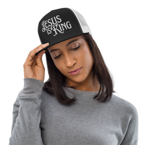 Woman wearing Black and White Jesus Is King flat bill trucker hat