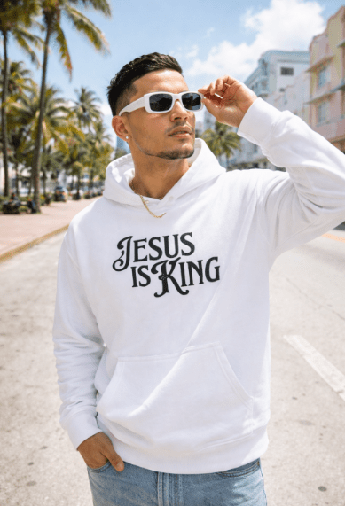 Man wearing white Jesus Is King Christian hoodie outdoors