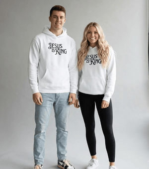 Man and woman wearing white Jesus Is King Christian hoodies