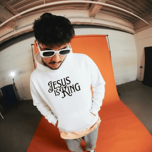 Man wearing white Jesus Is King Christian hoodie