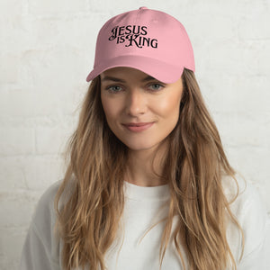 Woman wearing pink Jesus Is King women’s dad hat